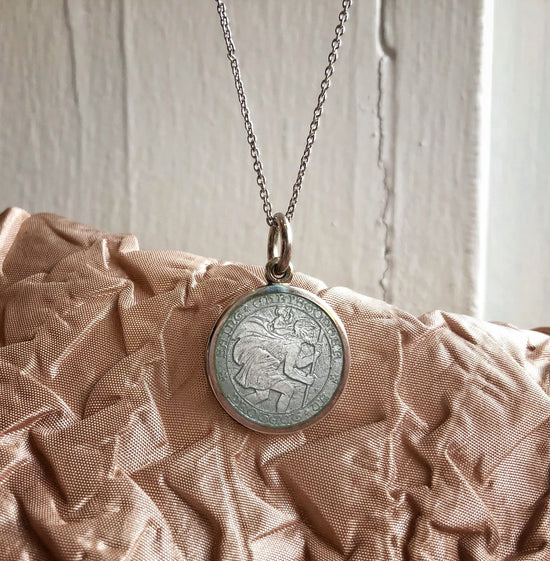 Photo of St. Christopher Pendant in a decorative scene, designed by , available at Plumb Gold & Plumb Silver