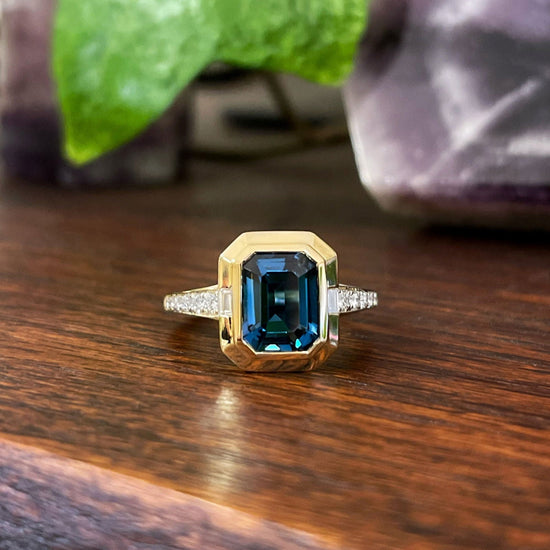 Photo of Stanton Color London Blue Topaz Ring in a decorative scene, designed by , available at Plumb Gold & Plumb Silver