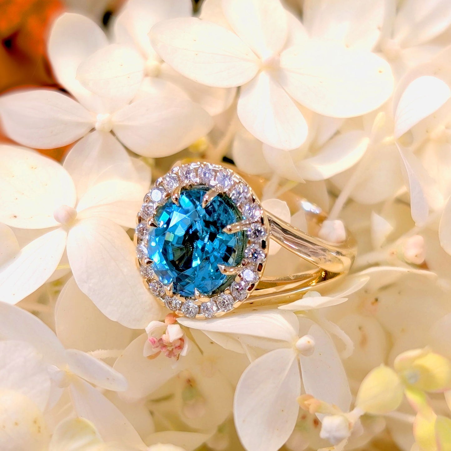 Photo of Statement Zircon Halo Ring in a decorative scene, designed by -, available at Plumb Gold & Plumb Silver