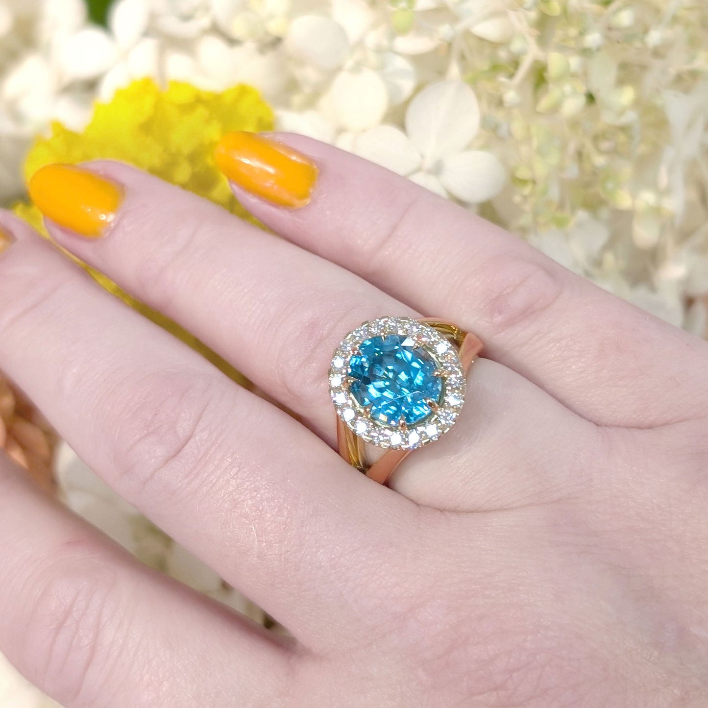 Photo of Statement Zircon Halo Ring in a decorative scene, designed by -, available at Plumb Gold & Plumb Silver