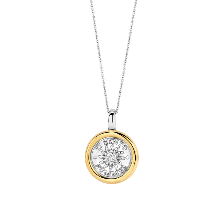 Photo of Summer Sun Coin Pendant in a decorative scene, designed by , available at Plumb Gold & Plumb Silver