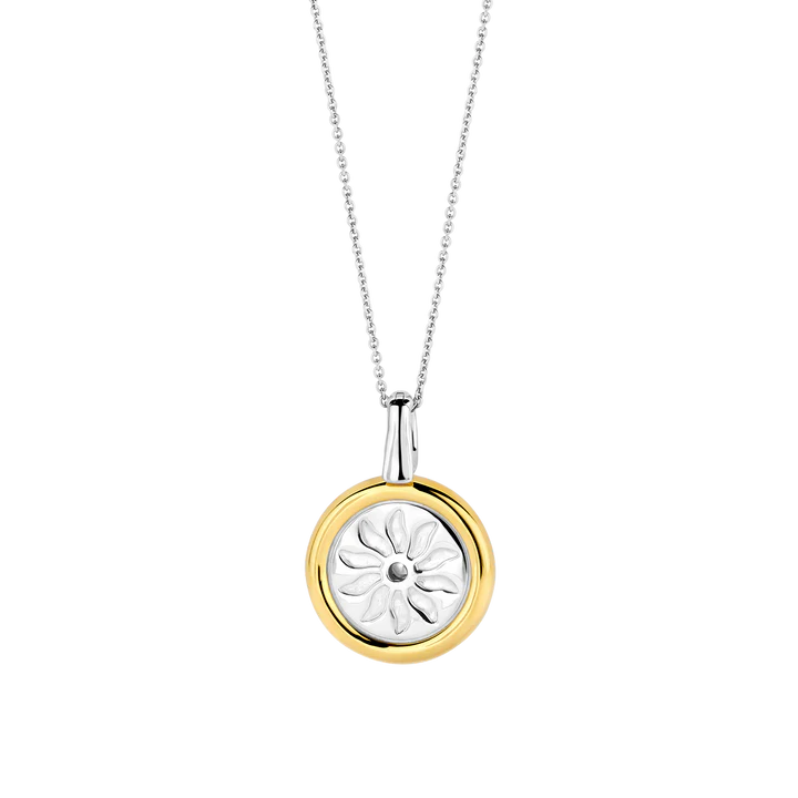 Photo of Summer Sun Coin Pendant in a decorative scene, designed by , available at Plumb Gold & Plumb Silver