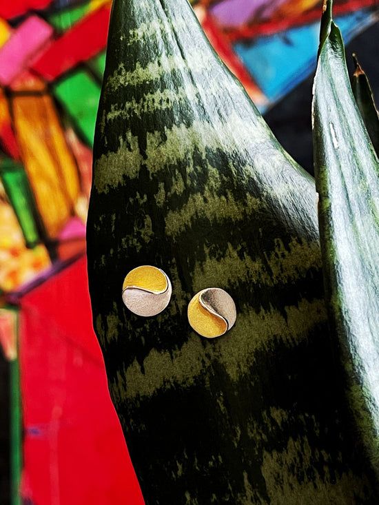 Photo of "Sun" Earrings in a decorative scene, designed by , available at Plumb Gold & Plumb Silver