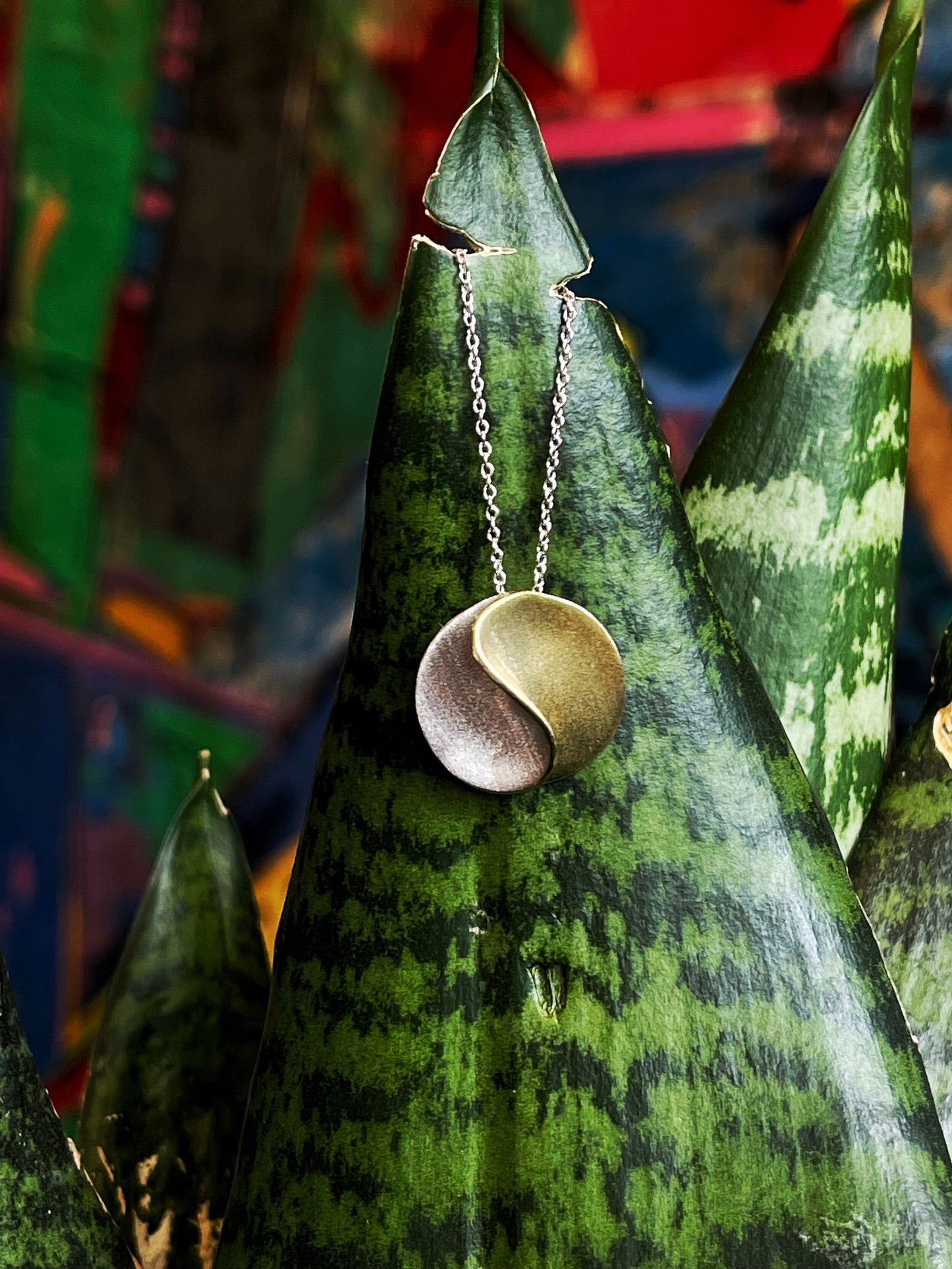 Photo of "Sun" Necklace in a decorative scene, designed by , available at Plumb Gold & Plumb Silver