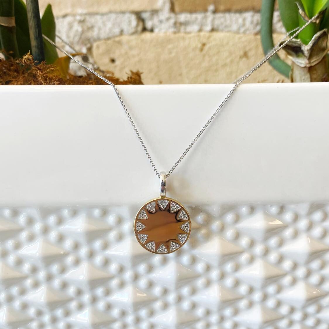 Photo of Sunburst Necklace in a decorative scene, designed by , available at Plumb Gold & Plumb Silver