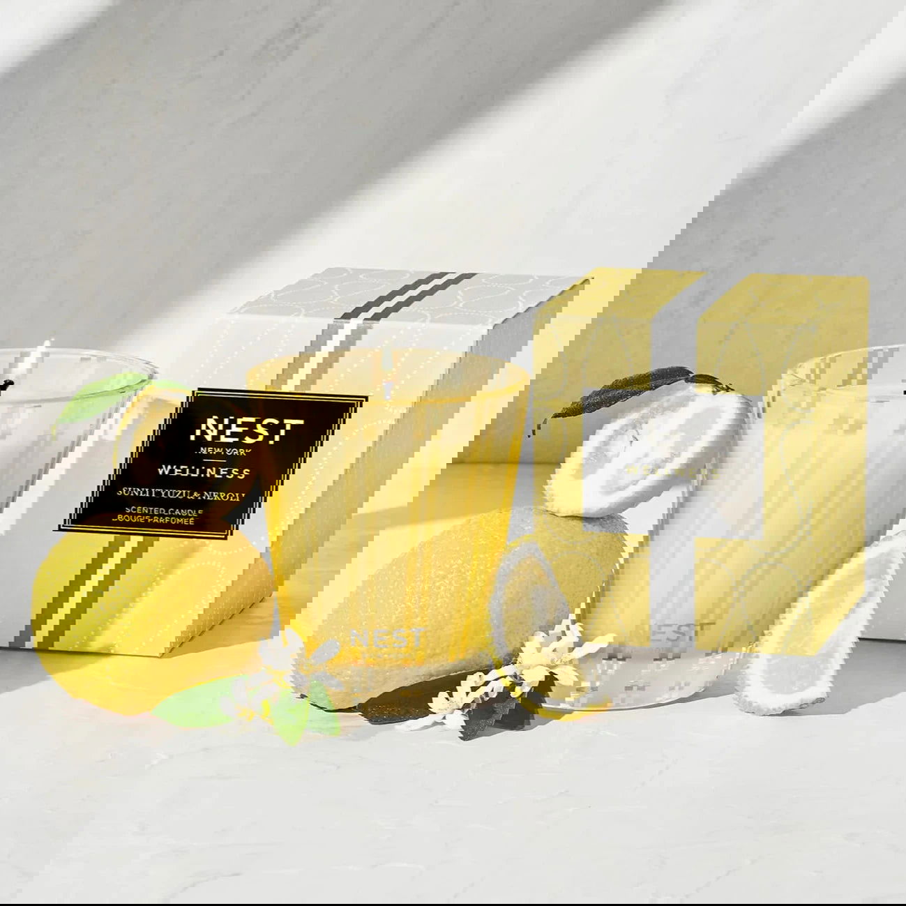 Photo of Sunlit Yuzu and Neroli Candle in a decorative scene, designed by , available at Plumb Gold & Plumb Silver