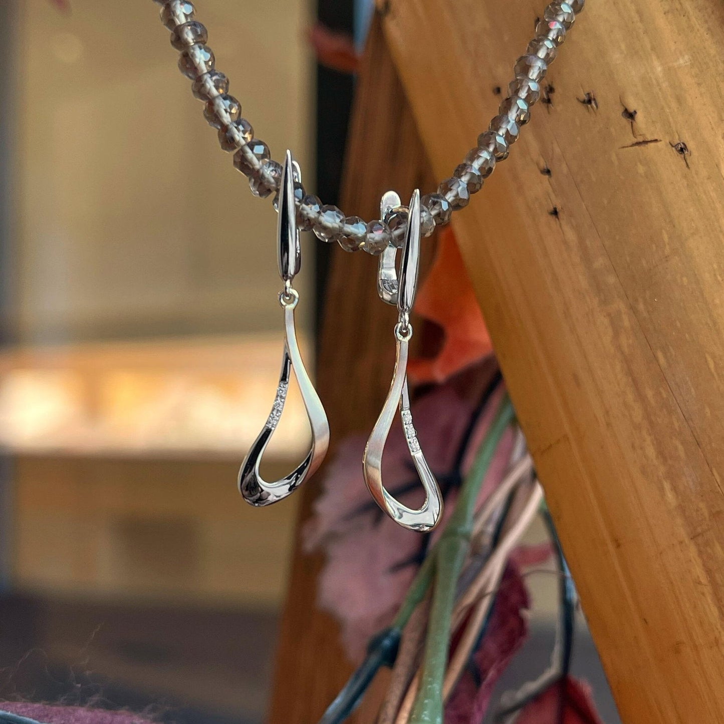 Photo of Swoop Dangles in a decorative scene, designed by , available at Plumb Gold & Plumb Silver