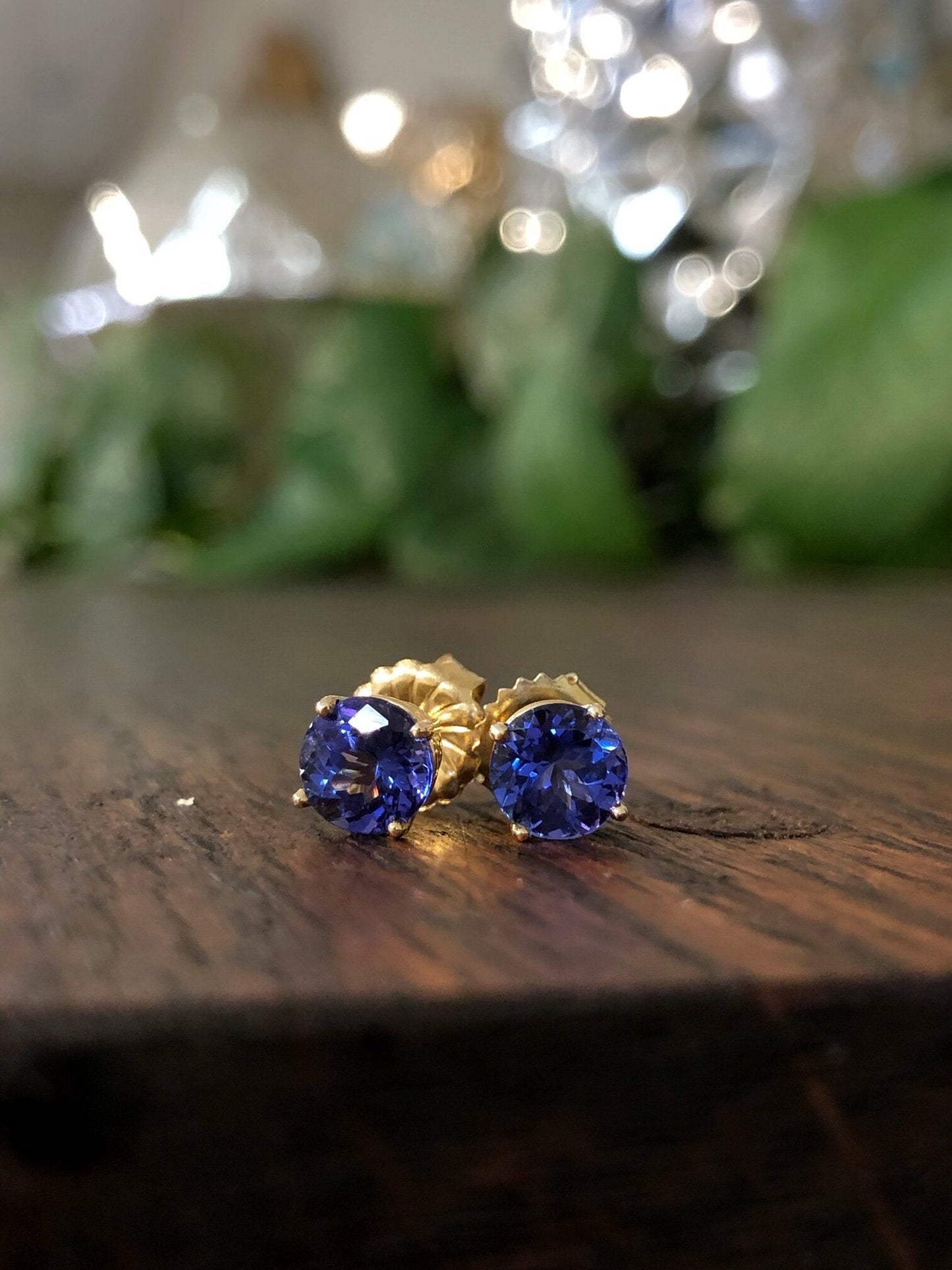 Photo of Tanzanite Studs in a decorative scene, designed by , available at Plumb Gold & Plumb Silver