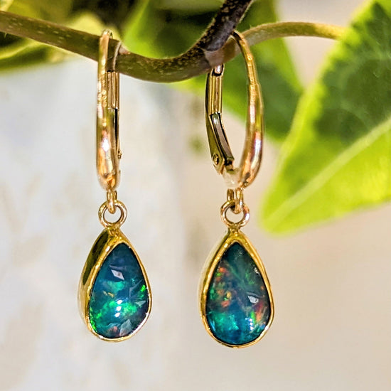 Photo of Teardrop Opal Pendant or Earrings in a decorative scene, designed by , available at Plumb Gold & Plumb Silver