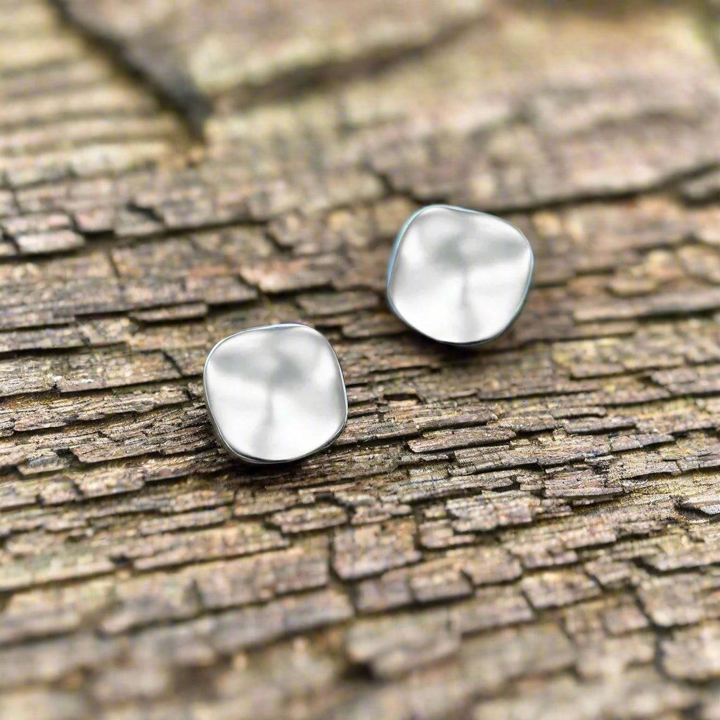 Photo of The "Aqua" Studs in a decorative scene, designed by -, available at Plumb Gold & Plumb Silver