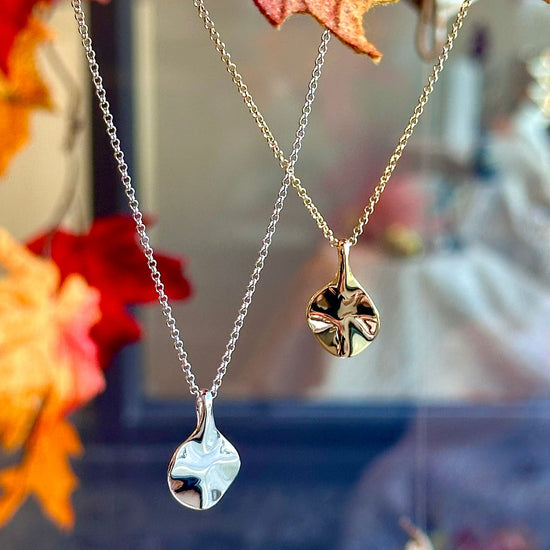 Photo of The Small "Aqua" Pendant in a decorative scene, designed by -, available at Plumb Gold & Plumb Silver