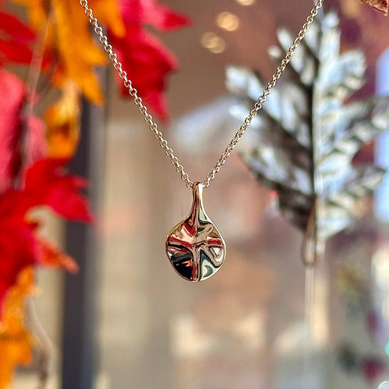 Photo of The Small "Aqua" Pendant in a decorative scene, designed by -, available at Plumb Gold & Plumb Silver