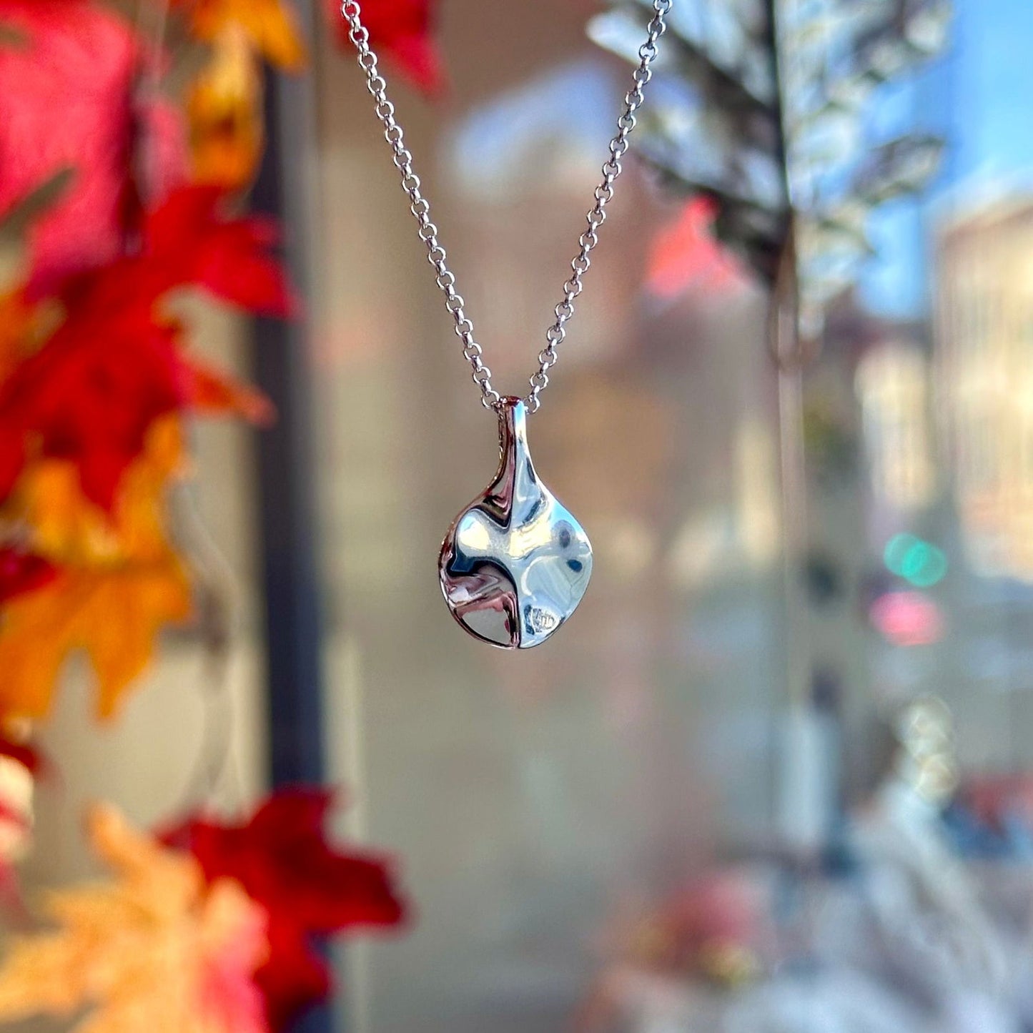 Photo of The Small "Aqua" Pendant in a decorative scene, designed by -, available at Plumb Gold & Plumb Silver