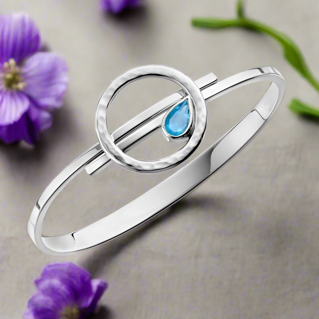 Photo of "Tilt a Wirl" Bracelet in a decorative scene, designed by , available at Plumb Gold & Plumb Silver