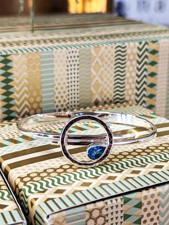 Photo of "Tilt a Wirl" Bracelet in a decorative scene, designed by , available at Plumb Gold & Plumb Silver