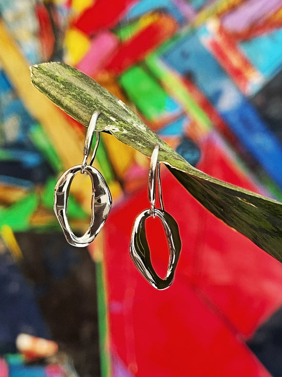 Photo of "Together" Earrings in a decorative scene, designed by , available at Plumb Gold & Plumb Silver