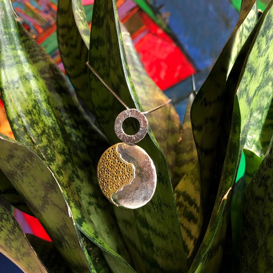 Photo of "Treasure" Pendant in a decorative scene, designed by , available at Plumb Gold & Plumb Silver