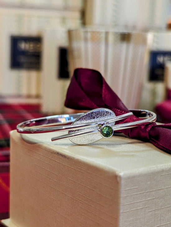 Photo of "Trill" Bracelet in a decorative scene, designed by , available at Plumb Gold & Plumb Silver