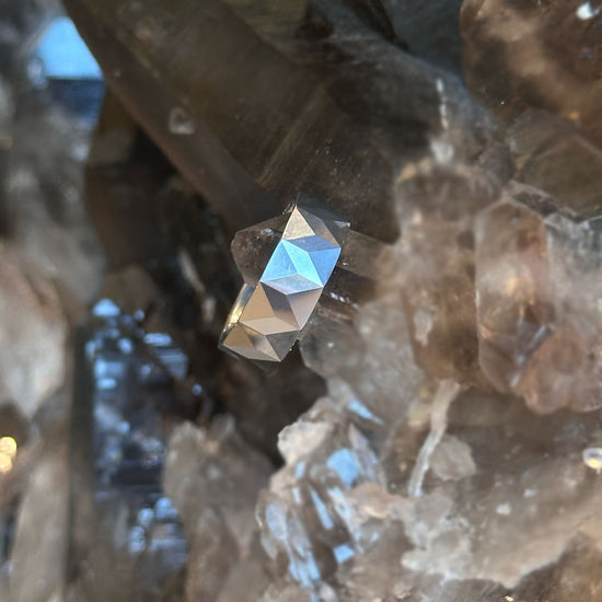 Photo of Tungsten Chevron Faceted Band in a decorative scene, designed by , available at Plumb Gold & Plumb Silver