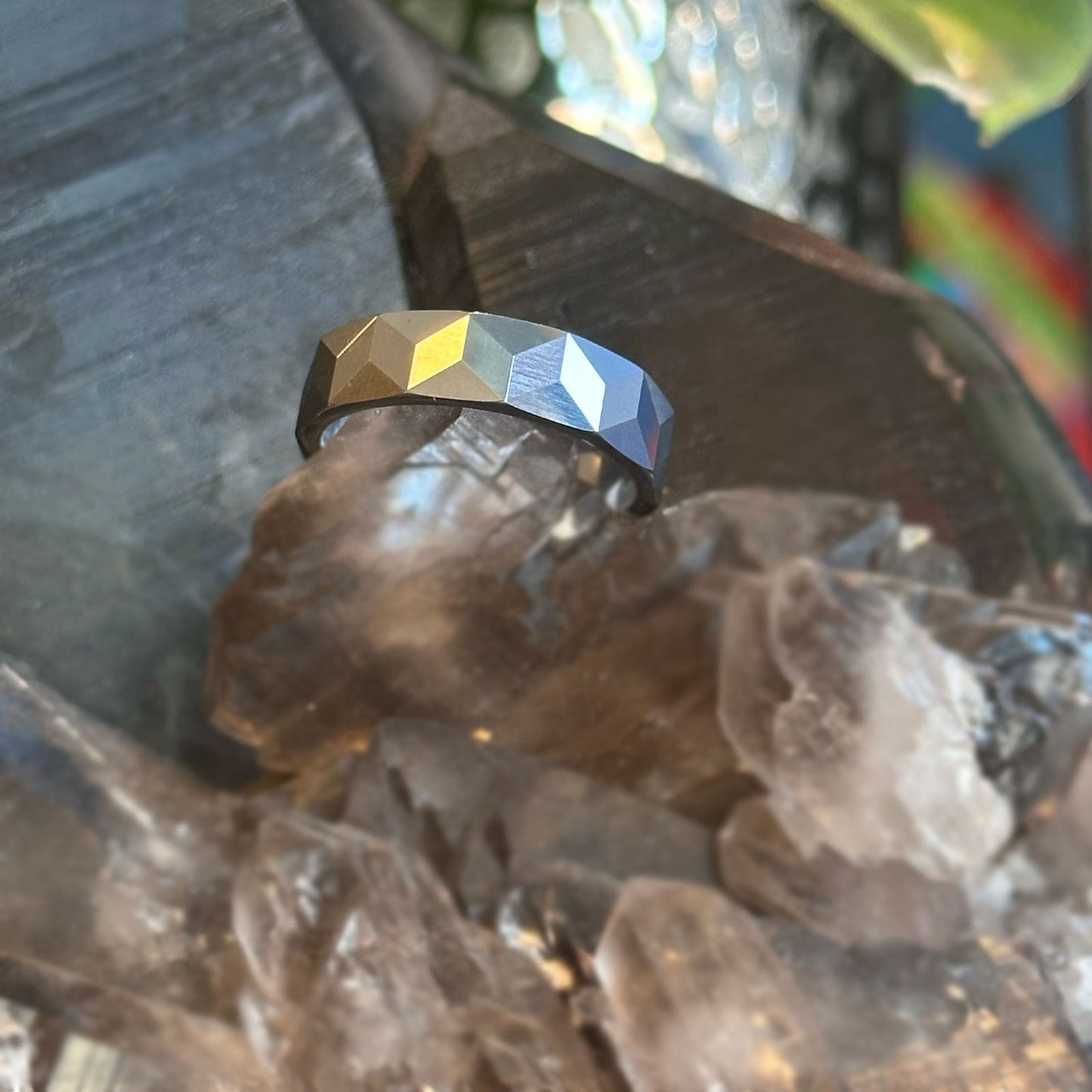 Photo of Tungsten Chevron Faceted Band in a decorative scene, designed by , available at Plumb Gold & Plumb Silver