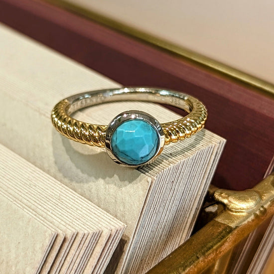 Load image into Gallery viewer, Photo of Turquoise Bezel Rope Ring in a decorative scene, designed by , available at Plumb Gold &amp;amp; Plumb Silver
