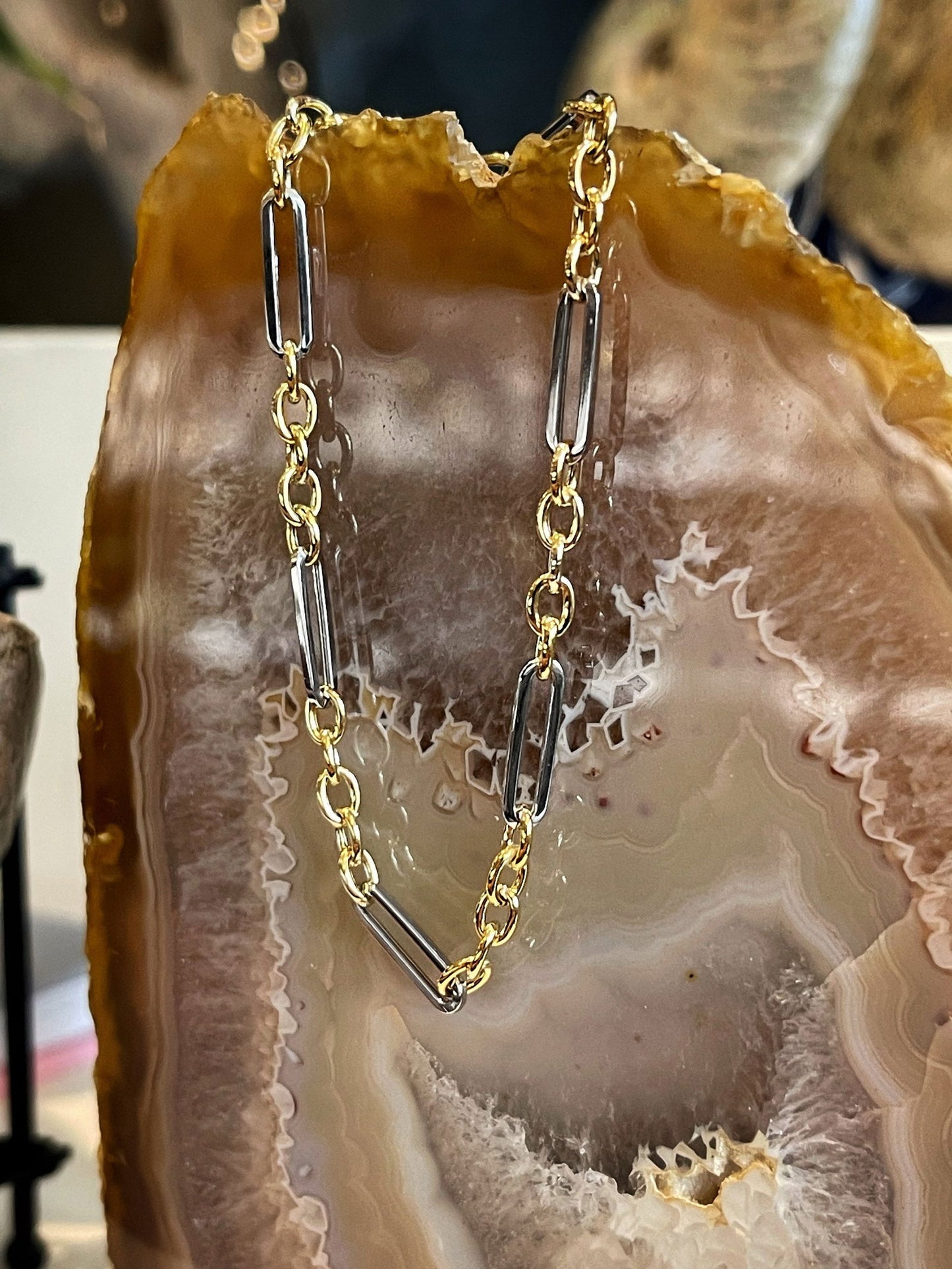 Photo of Two-Tone Fancy Link Bracelet in a decorative scene, designed by , available at Plumb Gold & Plumb Silver