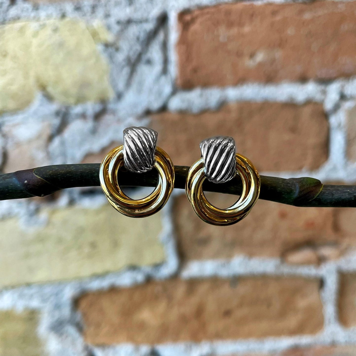 Photo of Two-tone Twisted Rope Studs in a decorative scene, designed by , available at Plumb Gold & Plumb Silver