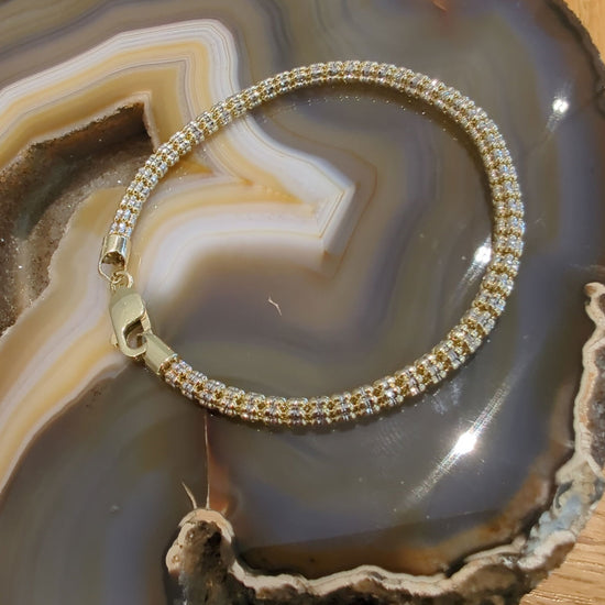 Photo of Vergano "Ice" link bracelet in a decorative scene, designed by , available at Plumb Gold & Plumb Silver