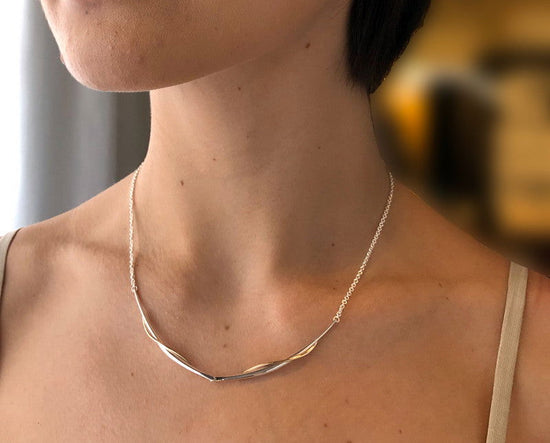 Photo of "Vineyard Swing" Necklace in a decorative scene, designed by , available at Plumb Gold & Plumb Silver