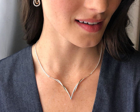 Photo of "Vineyard Swing" Necklace in a decorative scene, designed by , available at Plumb Gold & Plumb Silver