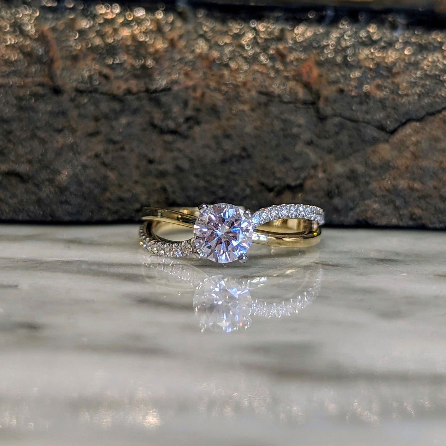 Photo of "Wave" Split Shank Engagement Ring in a decorative scene, designed by , available at Plumb Gold & Plumb Silver