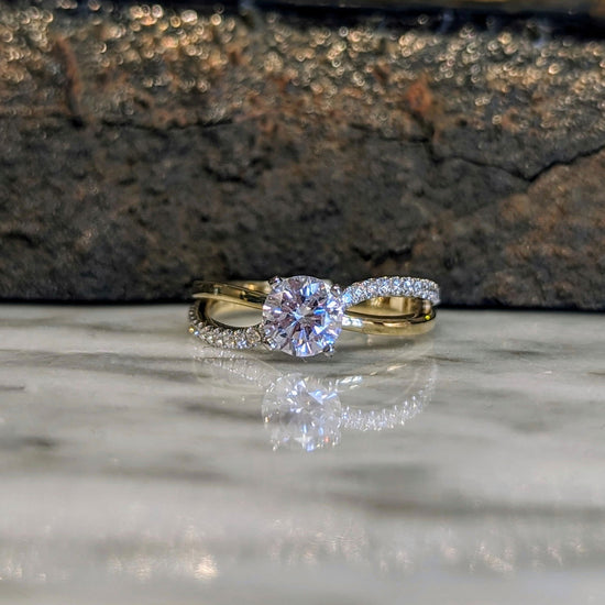 Photo of "Wave" Split Shank Engagement Ring in a decorative scene, designed by , available at Plumb Gold & Plumb Silver