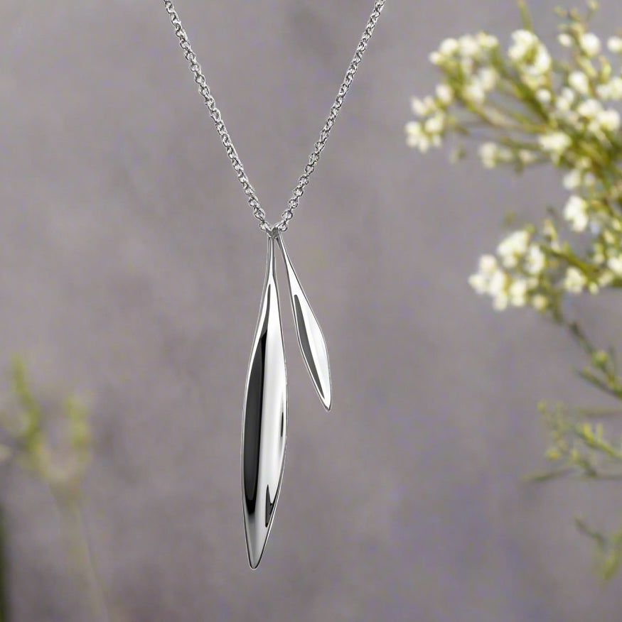 Photo of "Willow" Necklace in a decorative scene, designed by , available at Plumb Gold & Plumb Silver