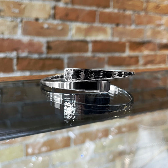 Photo of "Wisconsin" Swing Bracelet in a decorative scene, designed by , available at Plumb Gold & Plumb Silver