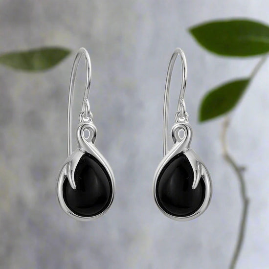 Photo of Wish Earrings in a decorative scene, designed by , available at Plumb Gold & Plumb Silver