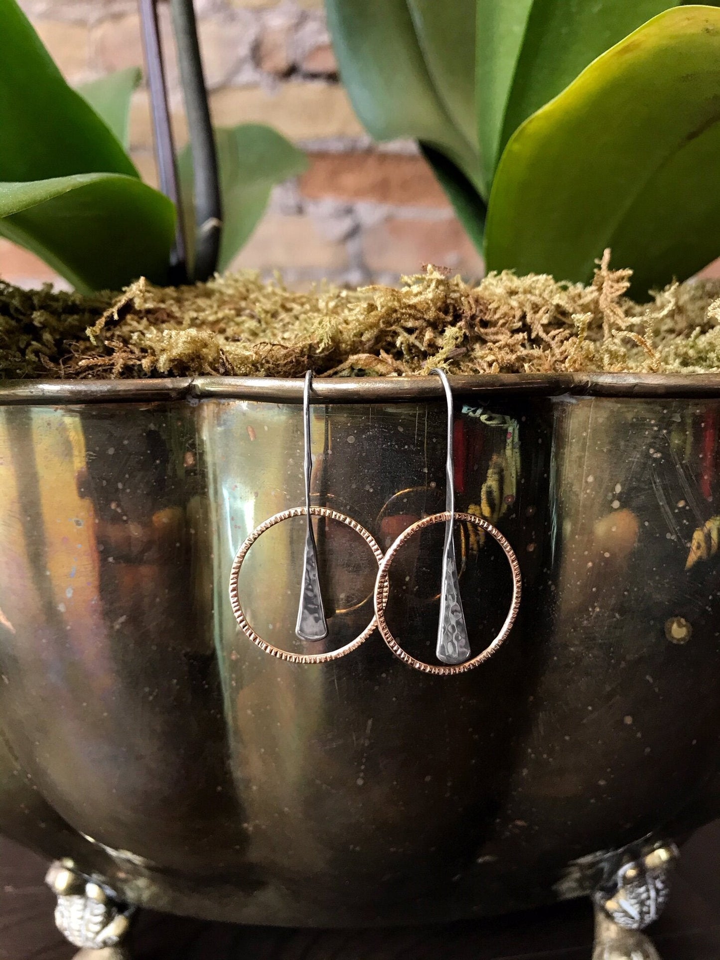 Photo of "Wishful" Earrings in a decorative scene, designed by , available at Plumb Gold & Plumb Silver