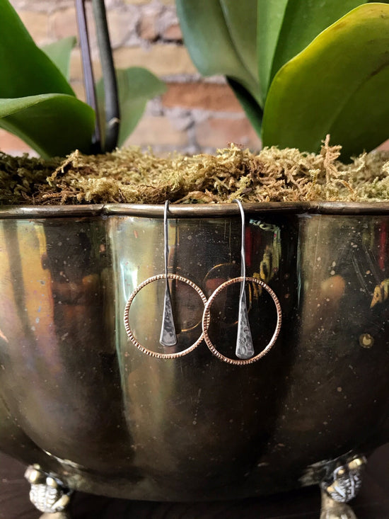 Photo of "Wishful" Earrings in a decorative scene, designed by , available at Plumb Gold & Plumb Silver