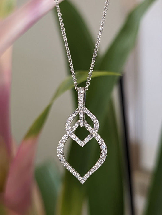 Photo of Woven Loop Pendant in a decorative scene, designed by , available at Plumb Gold & Plumb Silver