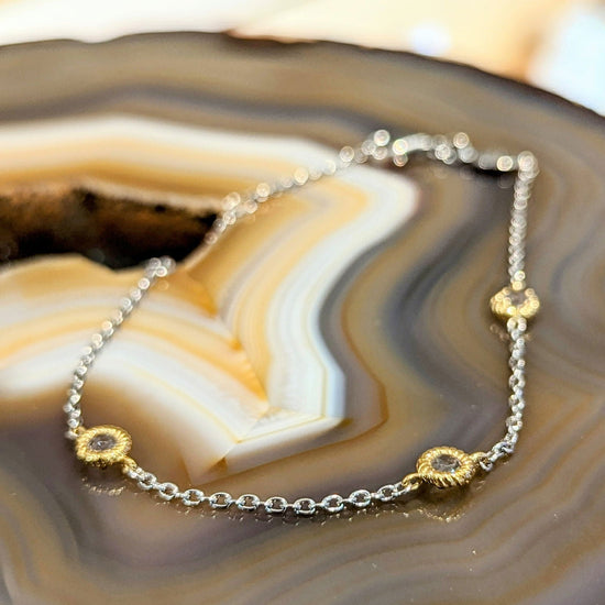 Photo of Yellow Gold Plate Accented CZ Station Bracelet in a decorative scene, designed by , available at Plumb Gold & Plumb Silver