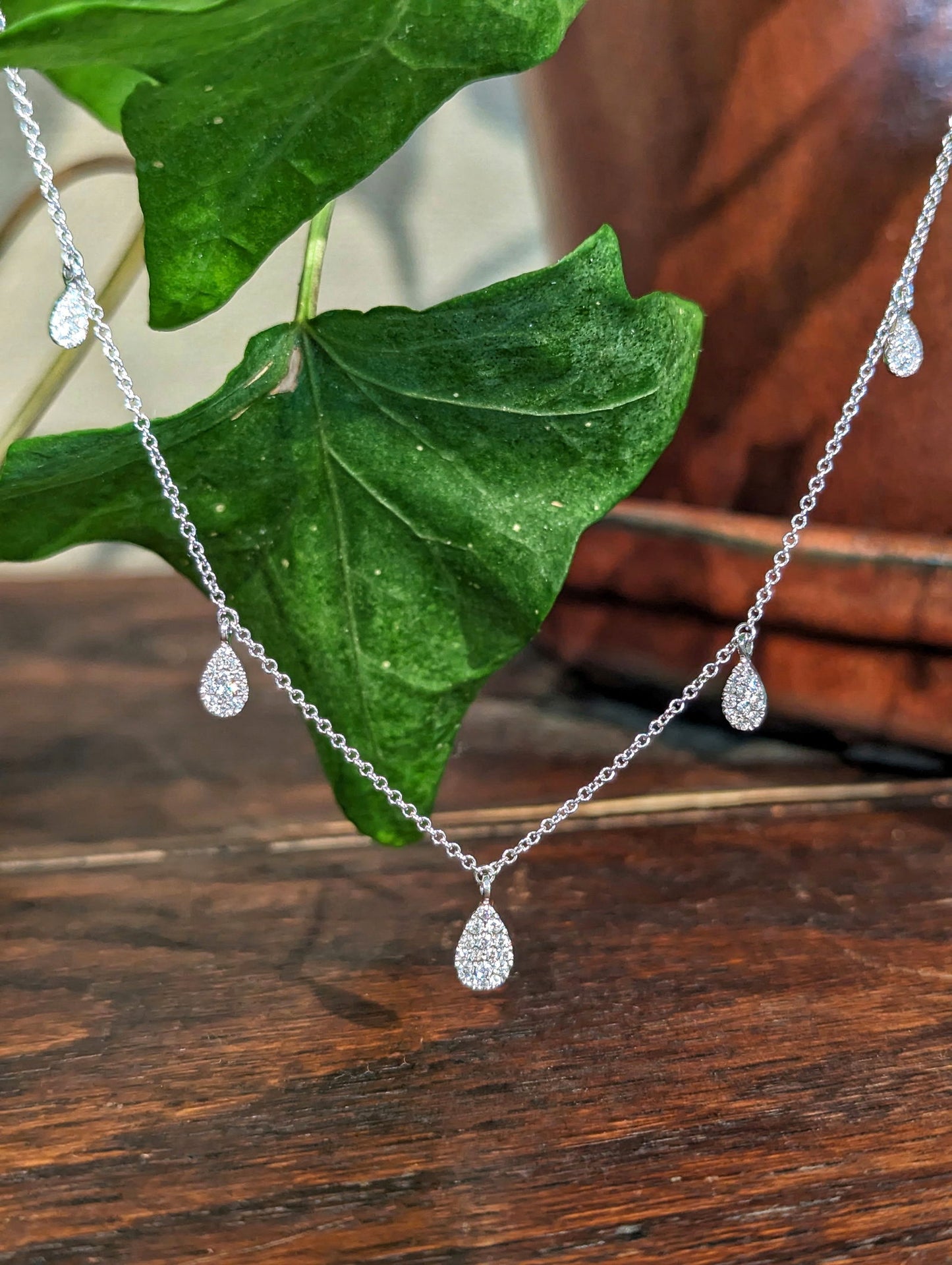 Photo of Zeghani Dancing Diamonds Necklace in a decorative scene, designed by , available at Plumb Gold & Plumb Silver