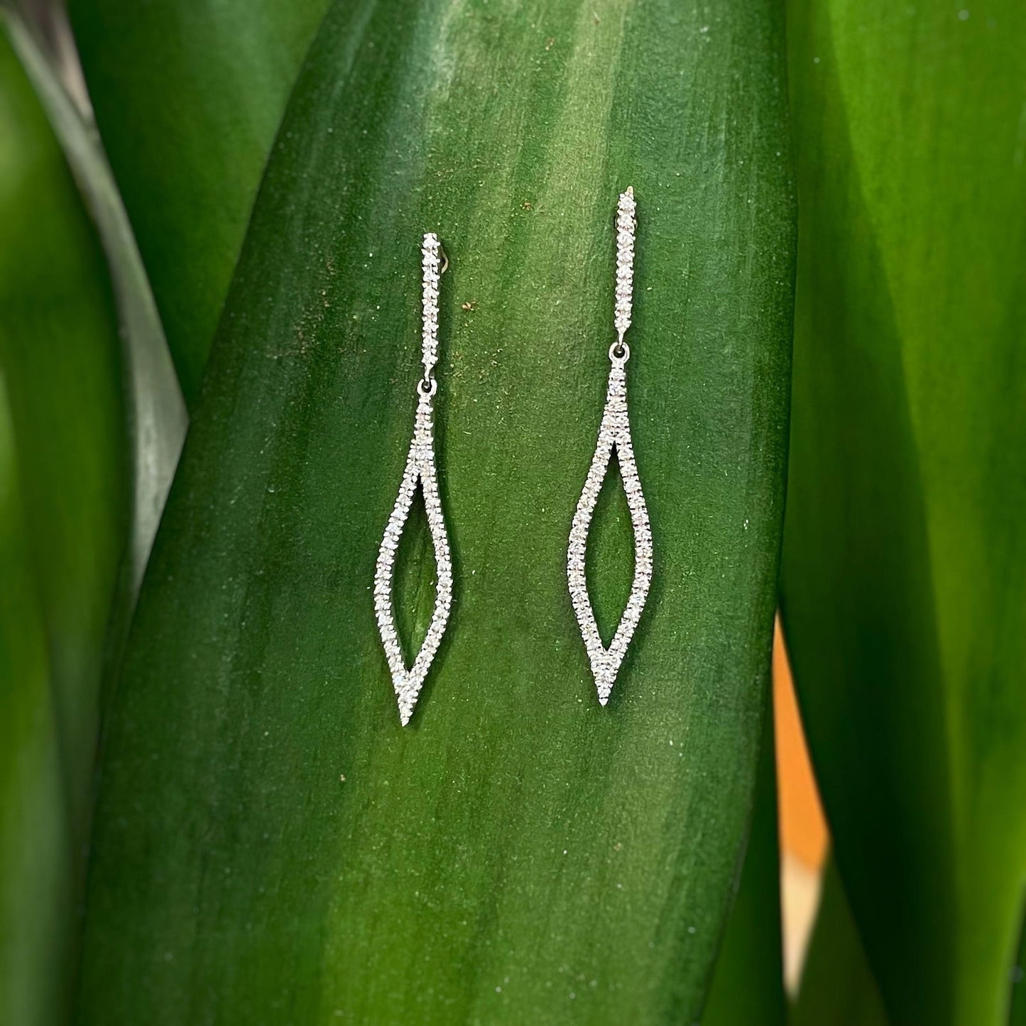 Photo of Zeghani Diamond Marquis Dangles in a decorative scene, designed by , available at Plumb Gold & Plumb Silver
