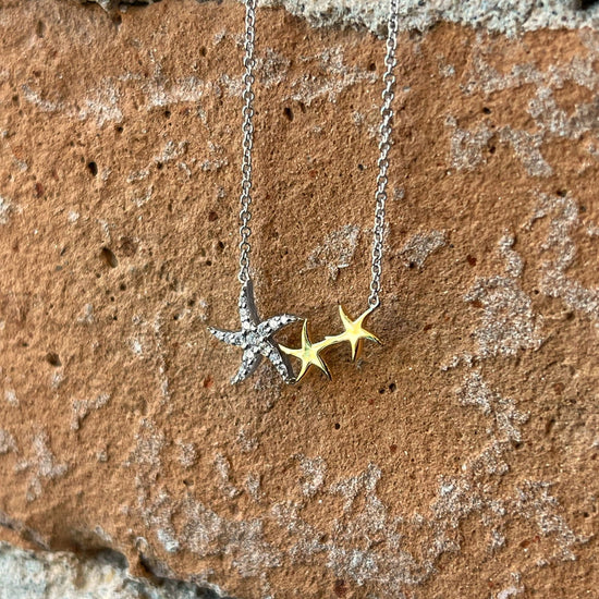 Photo of Zeghani Starfish Necklace in a decorative scene, designed by , available at Plumb Gold & Plumb Silver