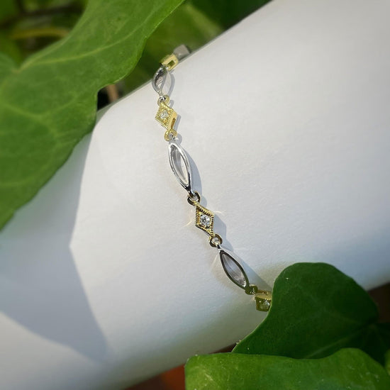 Photo of Zeghani Two Tone Diamond Bracelet in a decorative scene, designed by , available at Plumb Gold & Plumb Silver