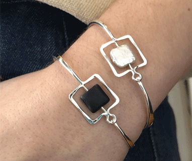Photo of "Zenith" Bangle in a decorative scene, designed by , available at Plumb Gold & Plumb Silver