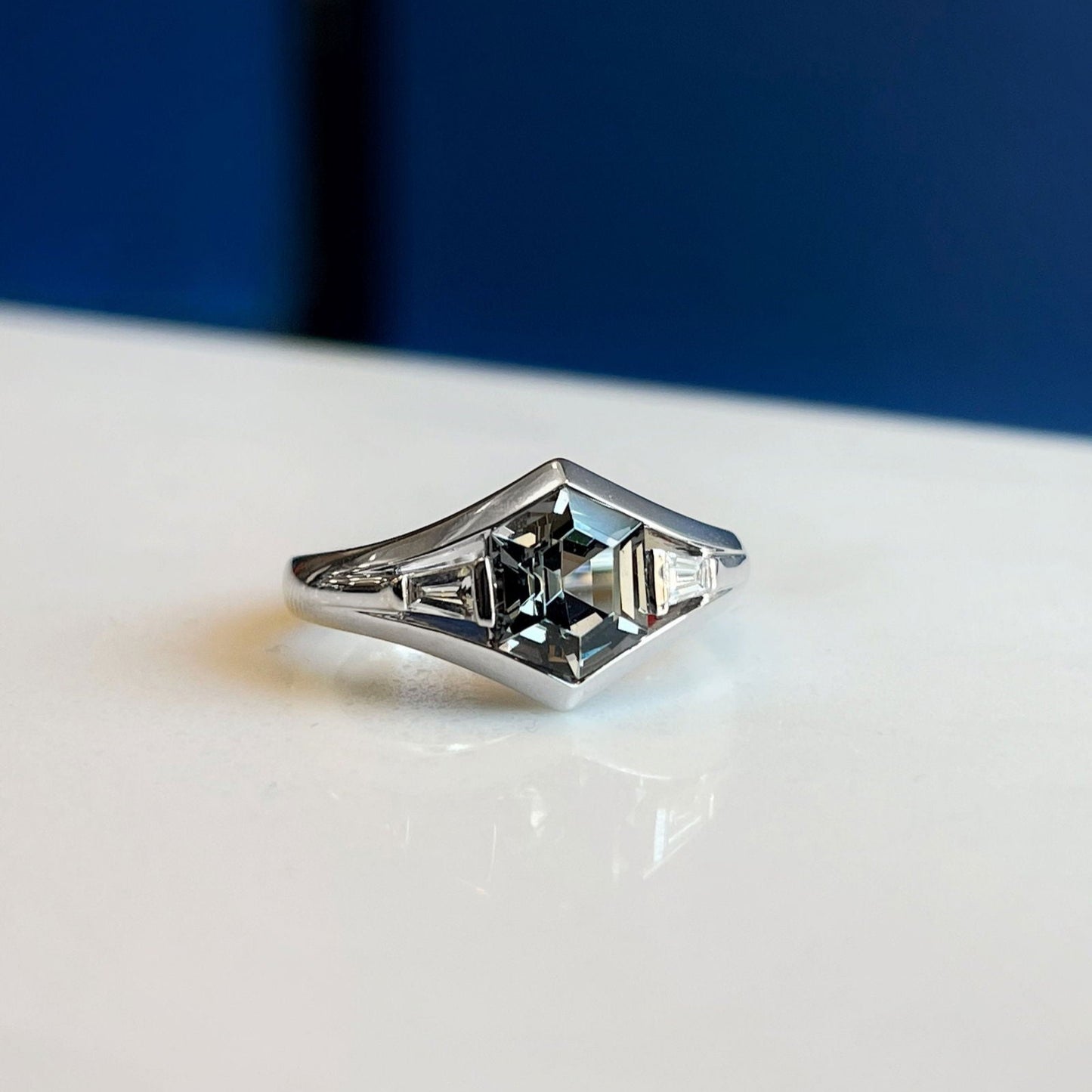 Photo of Zoma Color Grey Spinel Ring in a decorative scene, designed by , available at Plumb Gold & Plumb Silver