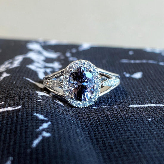 Photo of Zoma Color Grey Spinel &amp; Diamond Halo Ring in a decorative scene, designed by , available at Plumb Gold & Plumb Silver