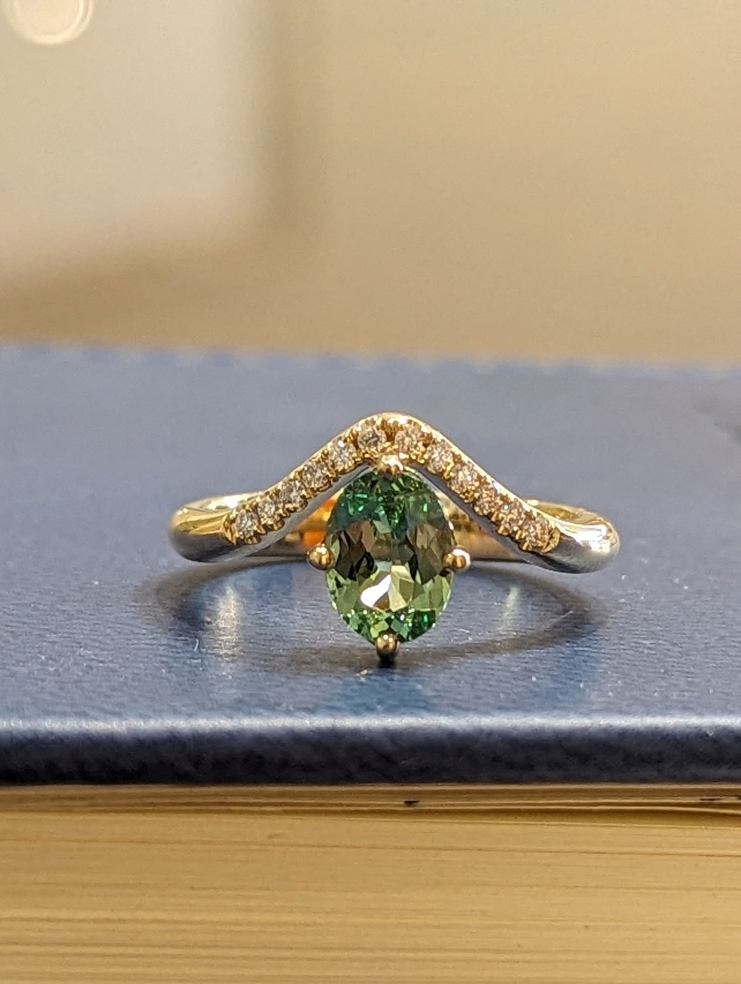 Photo of Zoma Color Mint Garnet and Diamond Ring in a decorative scene, designed by , available at Plumb Gold & Plumb Silver