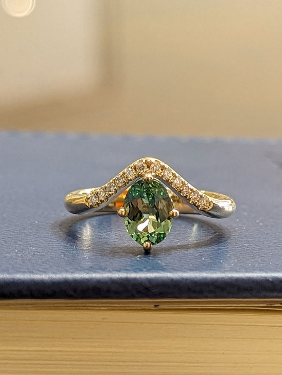 Photo of Zoma Color Mint Garnet and Diamond Ring in a decorative scene, designed by , available at Plumb Gold & Plumb Silver