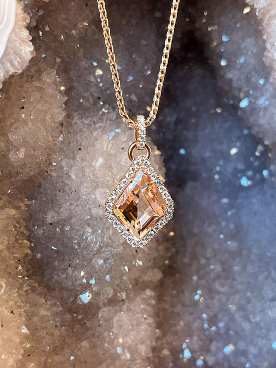Photo of Zoma Color Morganite & Diamond Pendant in a decorative scene, designed by , available at Plumb Gold & Plumb Silver
