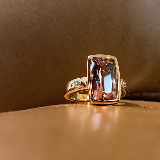 Photo of Zoma Color Pink Tourmaline Ring in a decorative scene, designed by , available at Plumb Gold & Plumb Silver